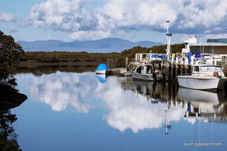 Fishing boats reflected in calm water at Port Franklin